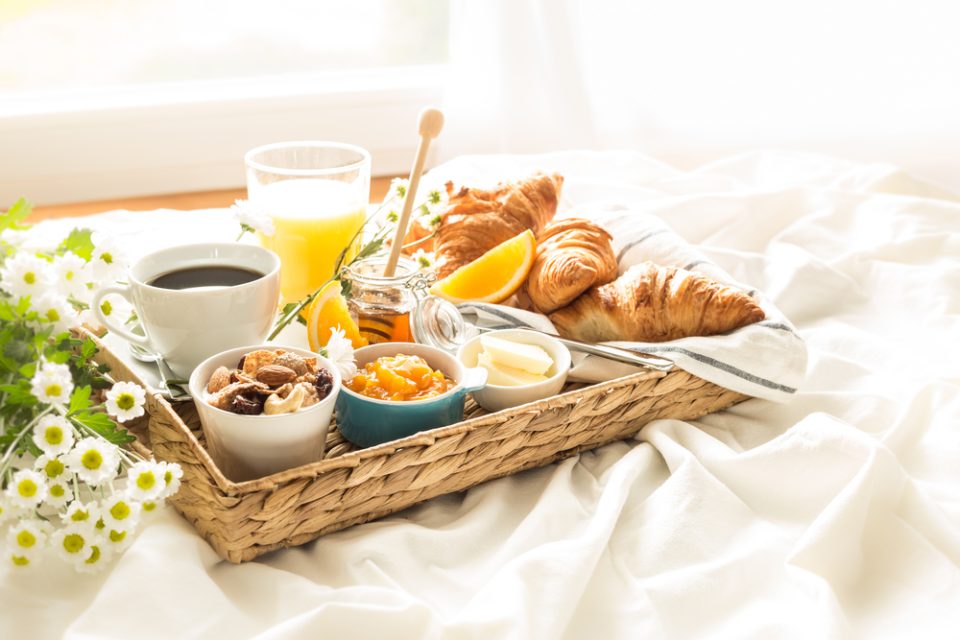 Continental,Breakfast,On,White,Bed,Sheets.,Coffee,,Orange,Juice,,Croissants,